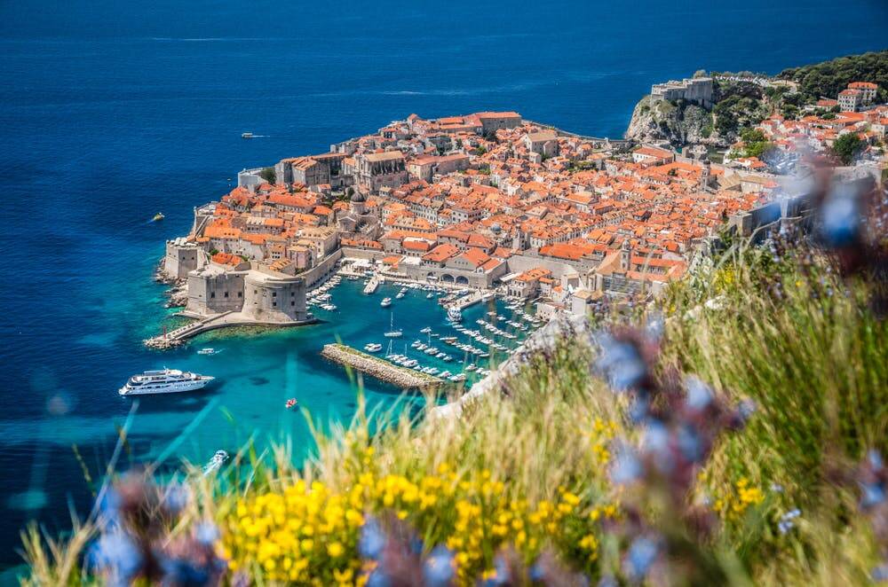 A city on a hill overlooking the ocean.