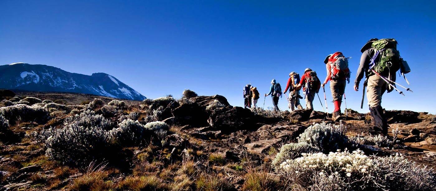 A group of hikers standing on top of a mountain.