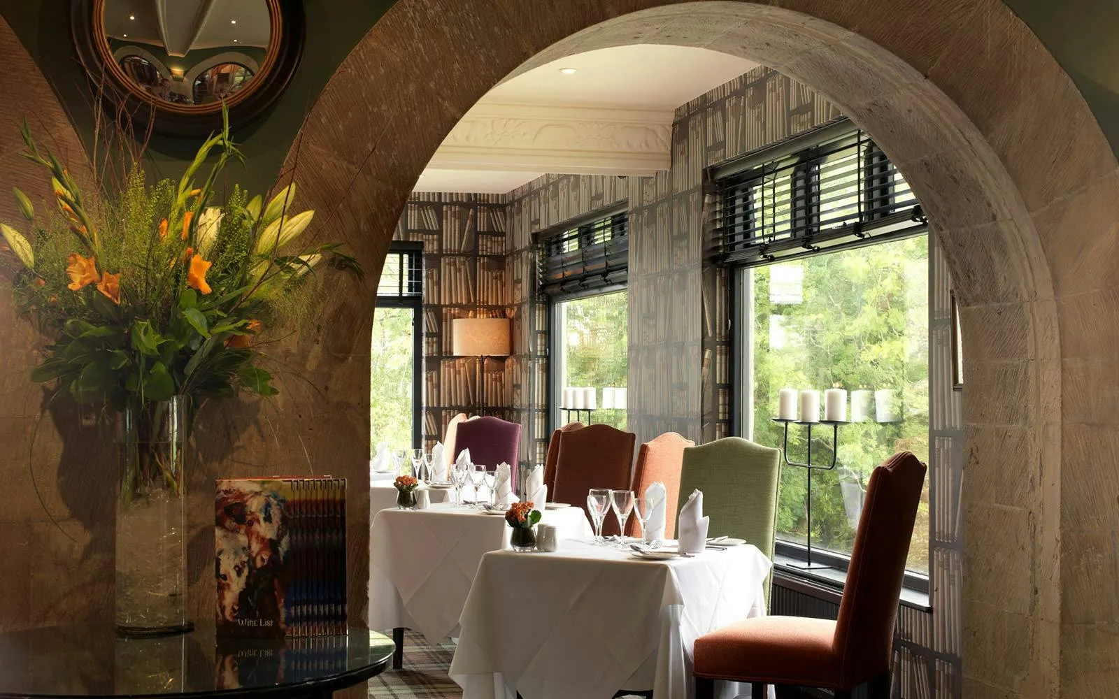 A dining room with a table and chairs.