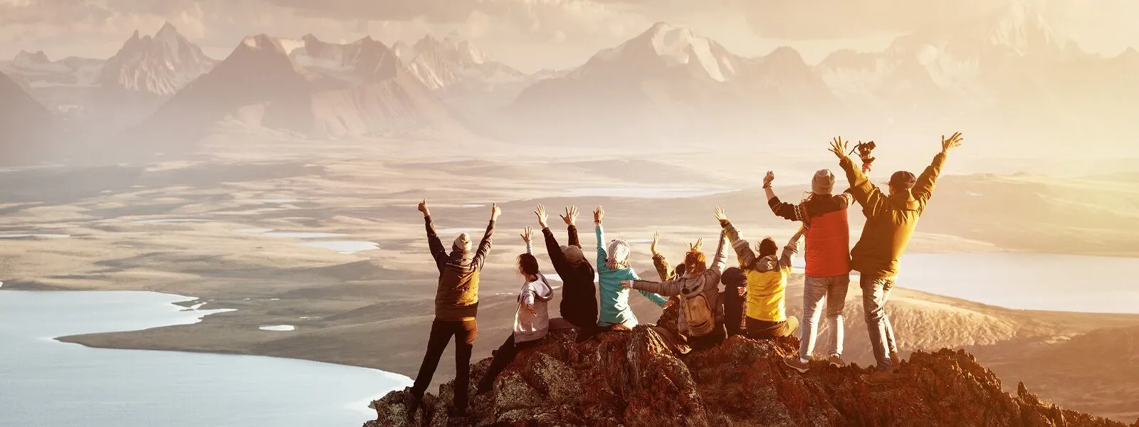 Group celebration on mountain peak