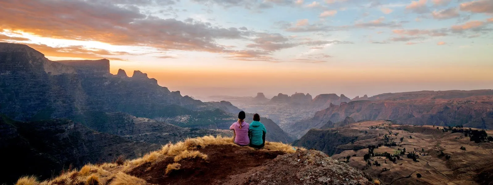 sitting on a mountain cliff
