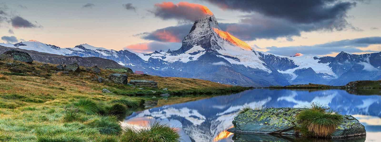 A mountain peak is reflected in a lake.