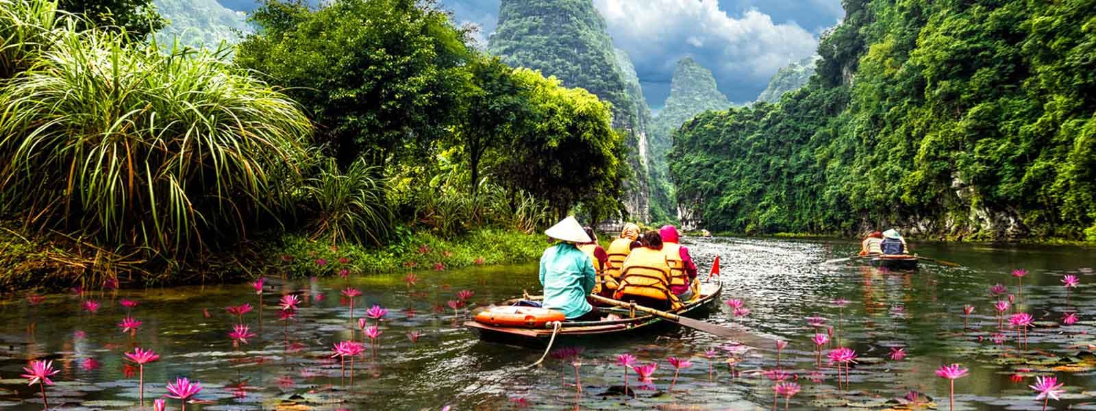A group of people in a boat on a river.