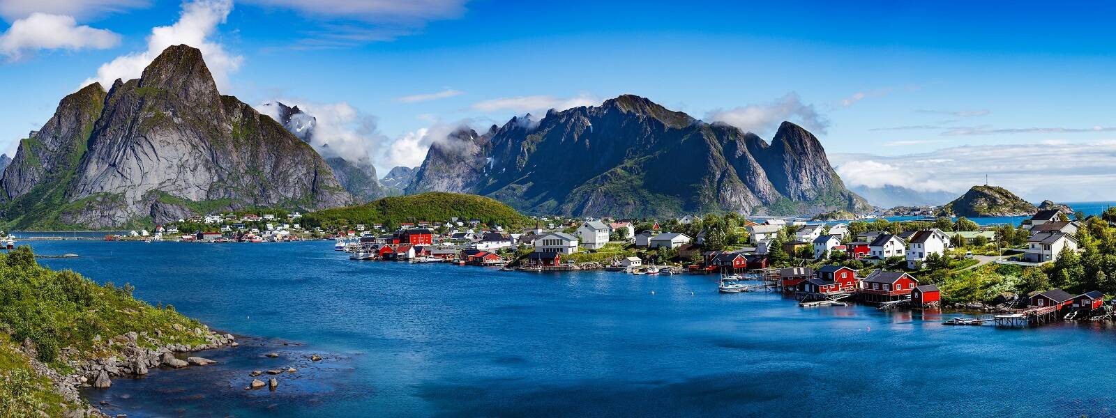 Adventure Travel: A small town located in the midst of towering mountains and picturesque bodies of water.